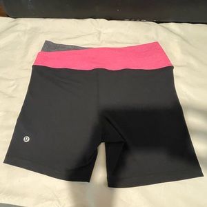 Lululemon cross front spandex shorts. Size 4. Black w/ pink and grey waistband.